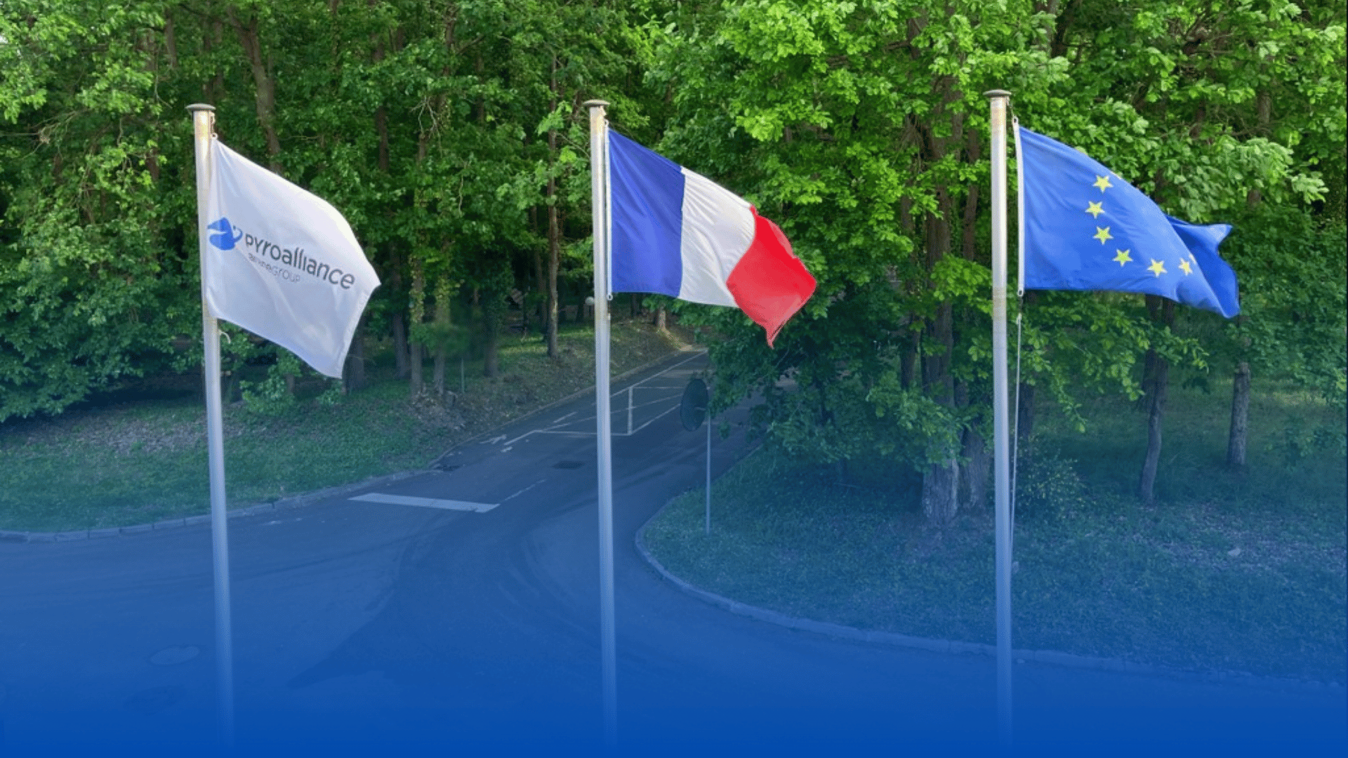Drapeaux de Pyroalliance, de la France et de l'Europe flottant au vent devant le batiment Pyroalliance